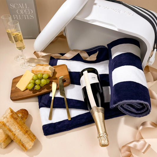 gifts-for-beach-lovers-in-esky-with-velour-towel-and-cheese-board-with-ribbed-stemmed-flutes