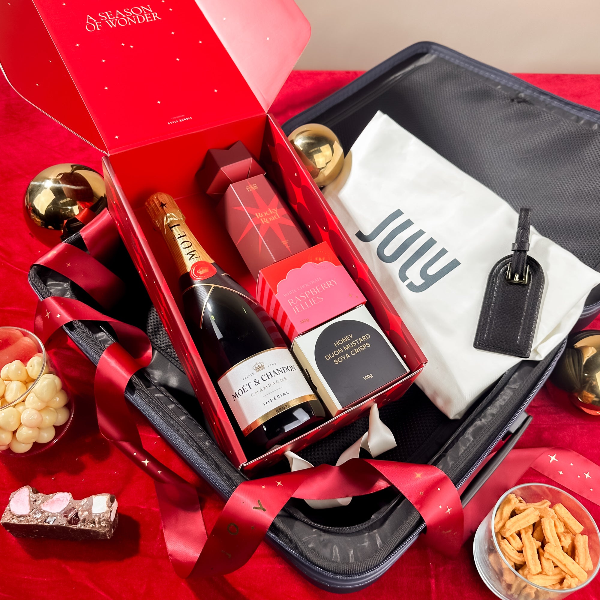 corporate-xmas-gifts-july-luggage-and-luggage-tag-with-champagne-hamper