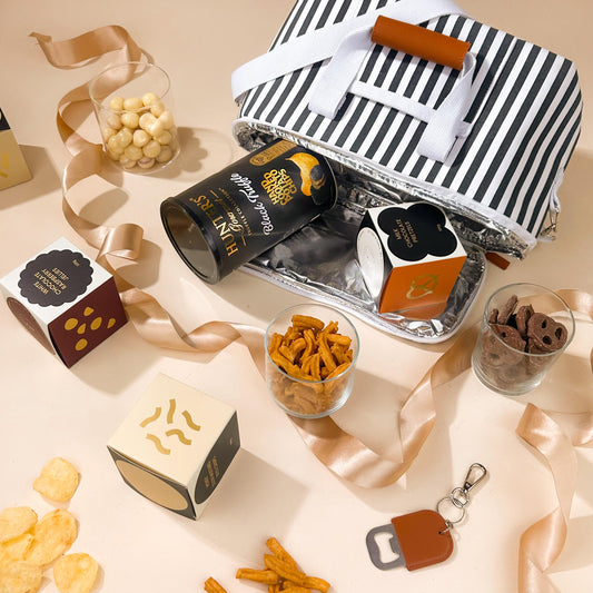 corporate-hamper-for-clients-in-striped-cooler-bag-with-hunter-truffle-chips-and-sweet-snacks