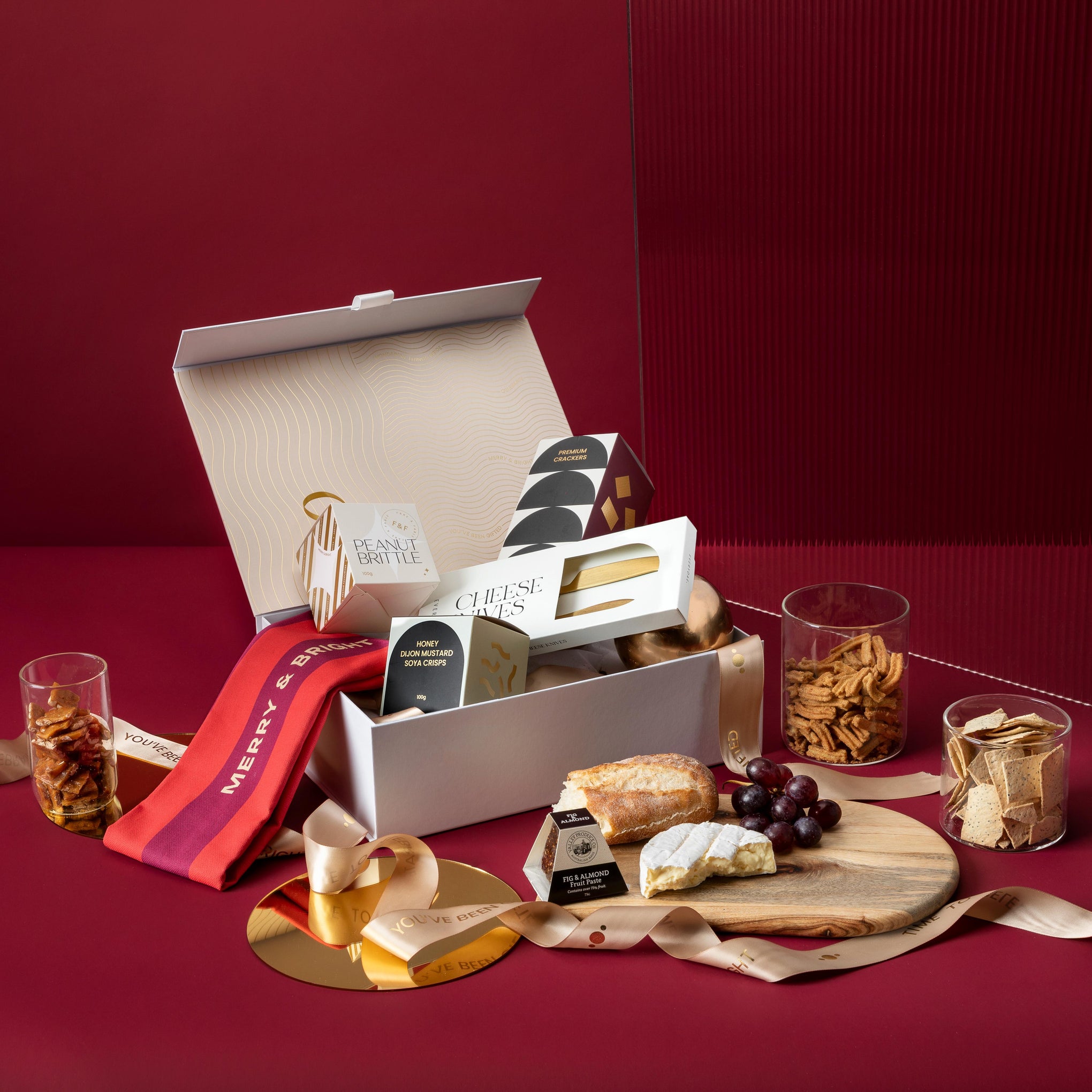 style-bundle-christmas-gifts-for-employees-the-festive-entertainer-with-arched-board-and-gold-cheese-knives-with-festive-tea-towel