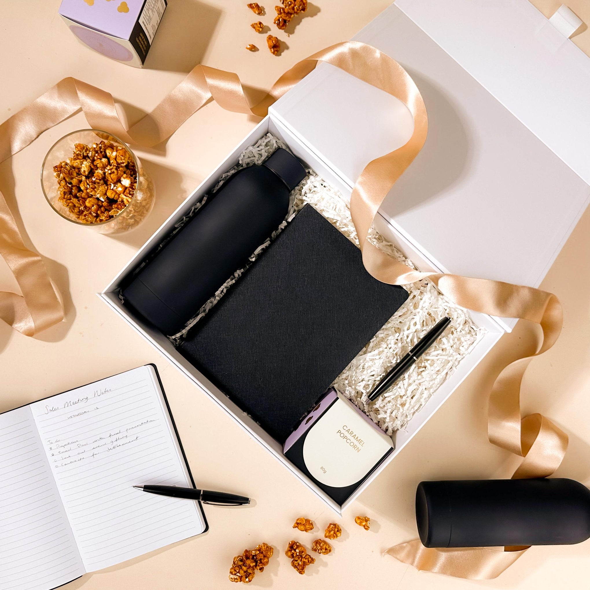 corporate-gifts-for-new-employees-with-journal-and-drink-bottle-and-pen-with-snacks